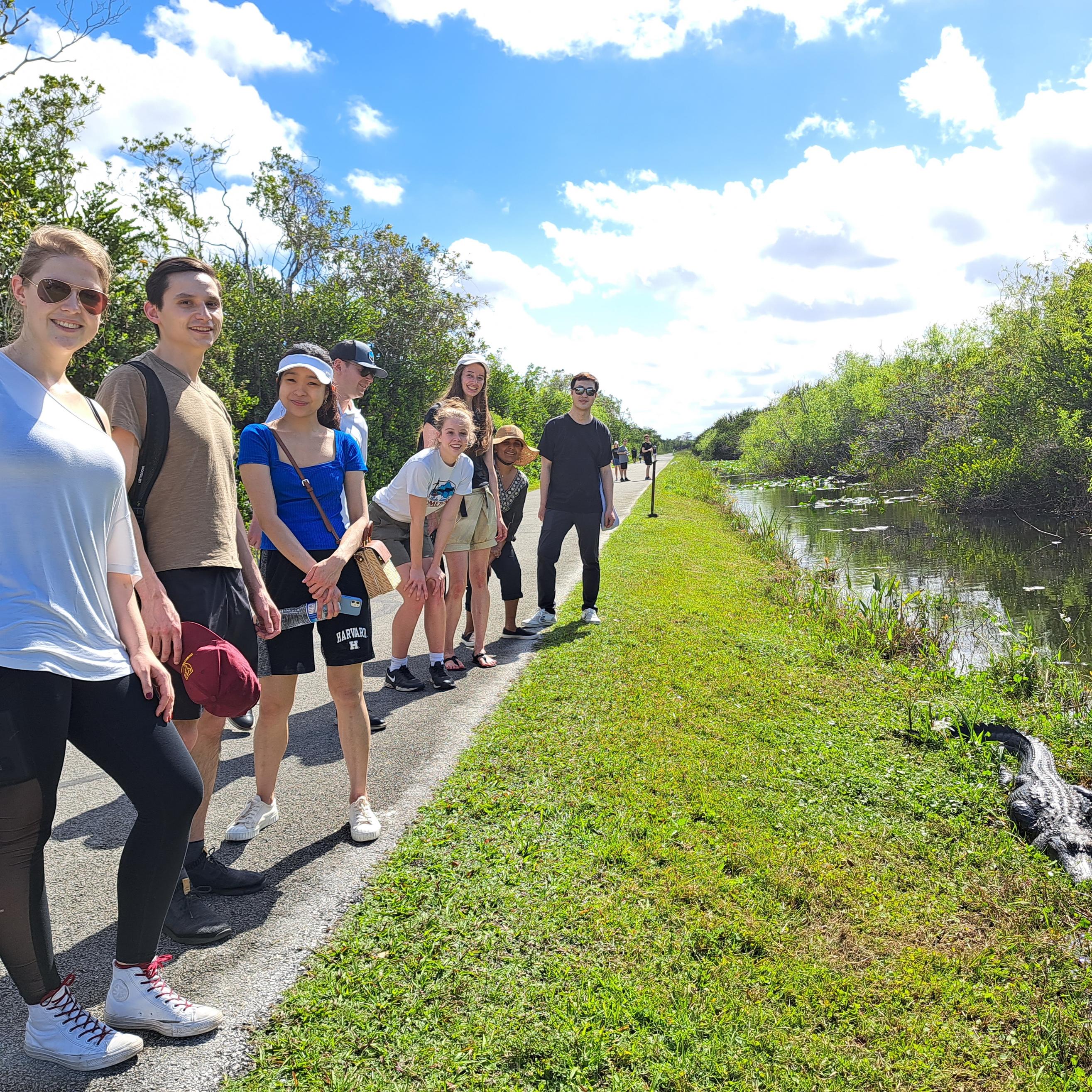 group posing near an alligator in the Everglades National Park