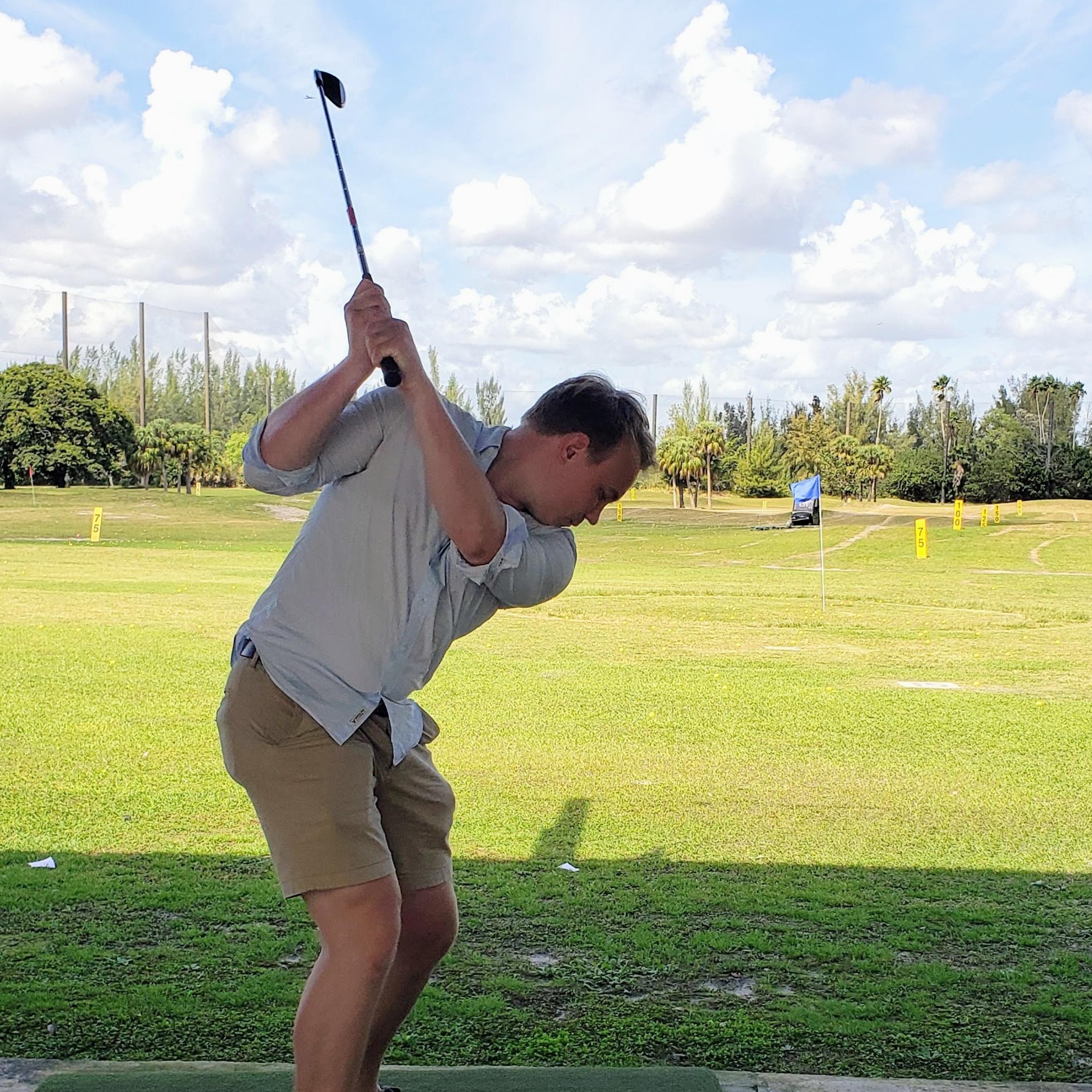 Allen swinging at the golf range
