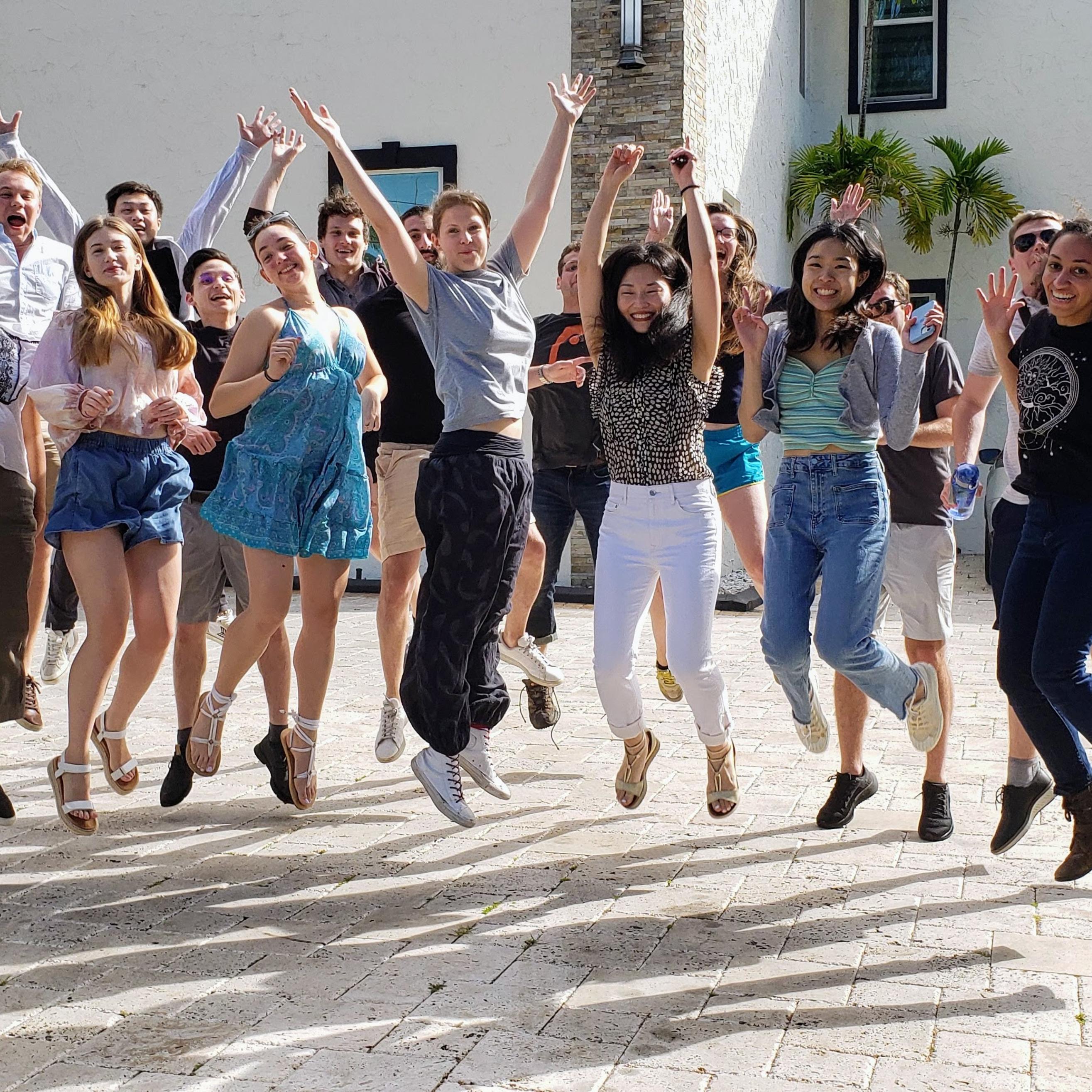jumping group photo in front of the Florida house