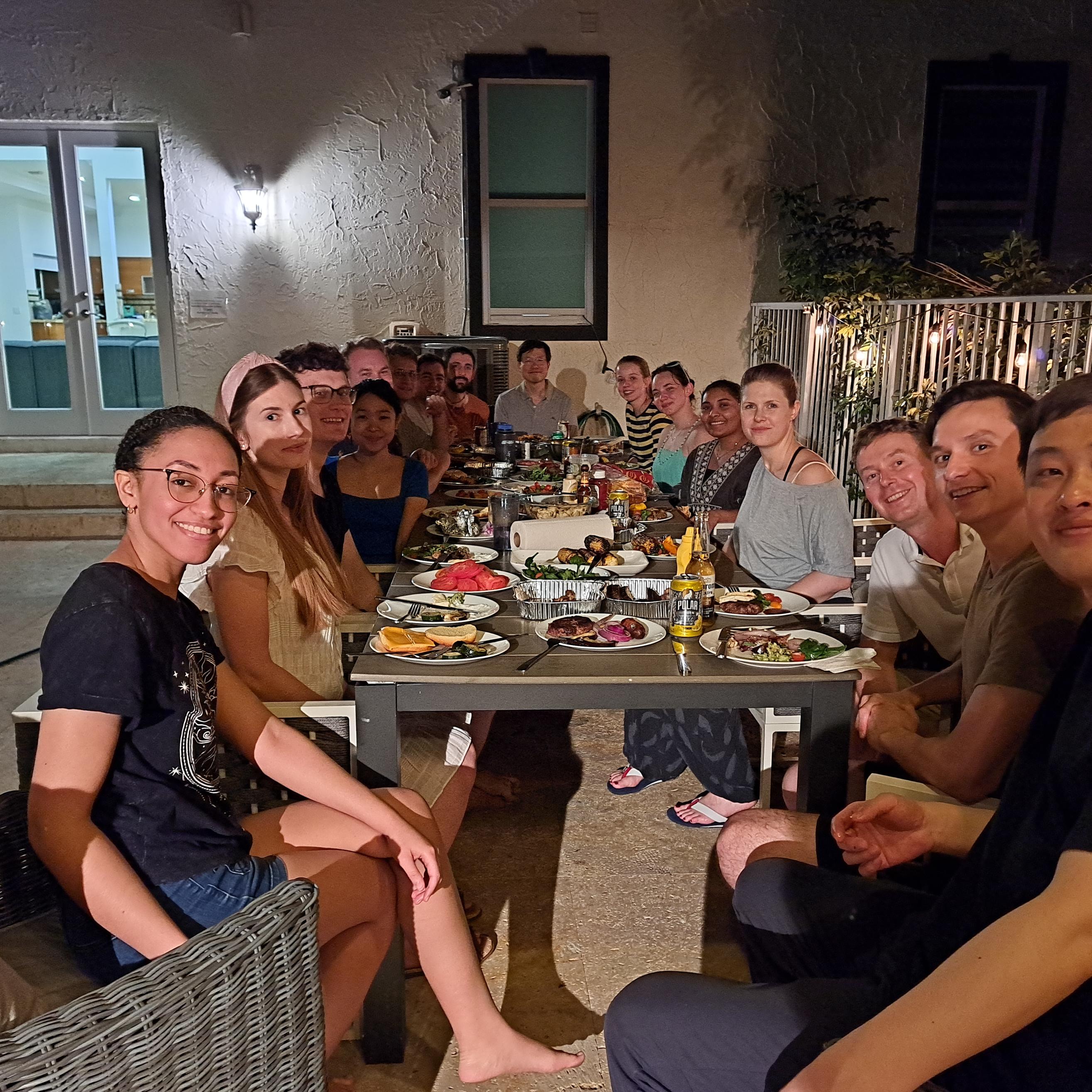 lab sitting down for an outdoor barbecue